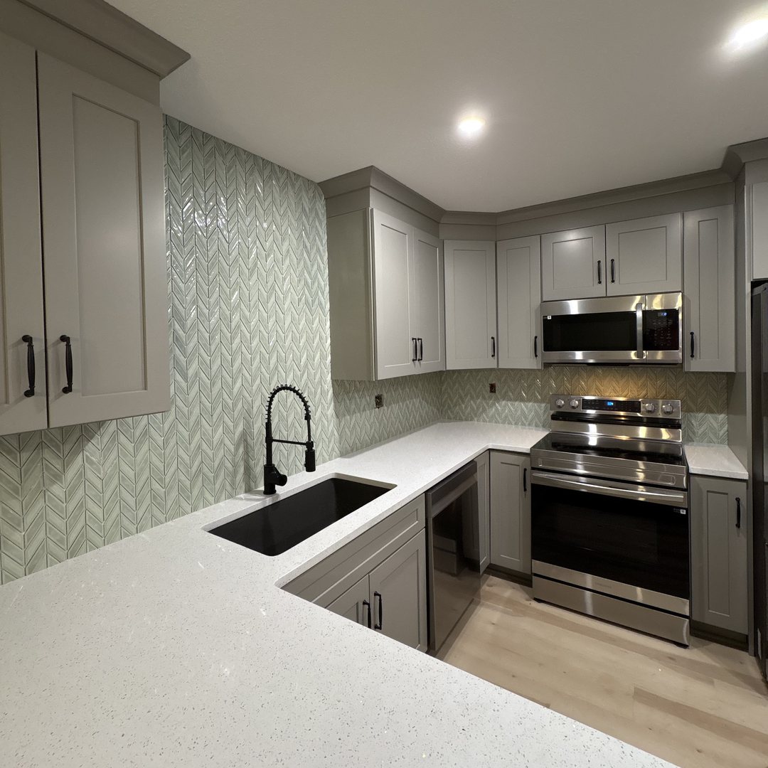 Kitchen renovation with gray shaker cabinets and herringbone tile backsplash, Masaryktown, Hernando County, FL